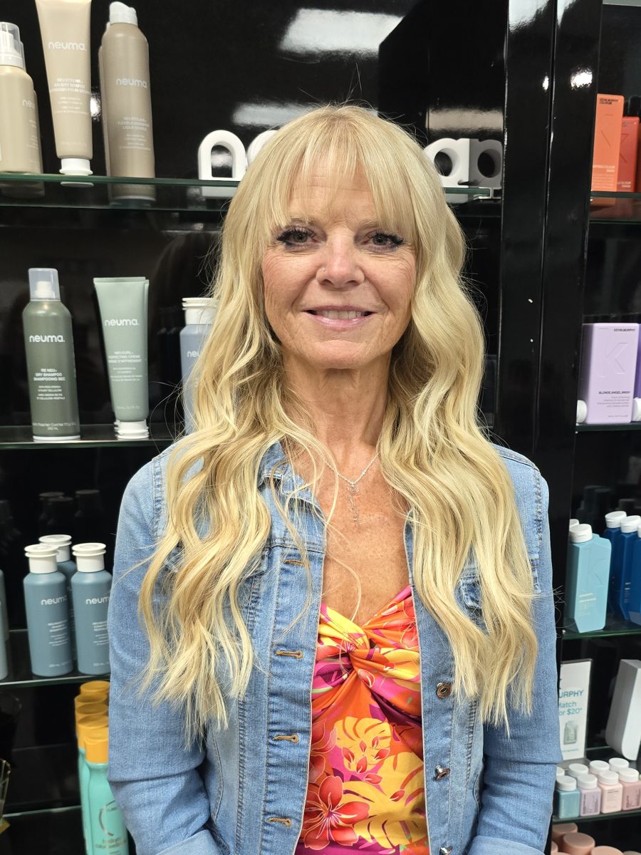 Front view of platinum blonde hair with bangs and long waves, by Kristan Sayers at K Bella Hair Studio & Spa in Brighton, MI