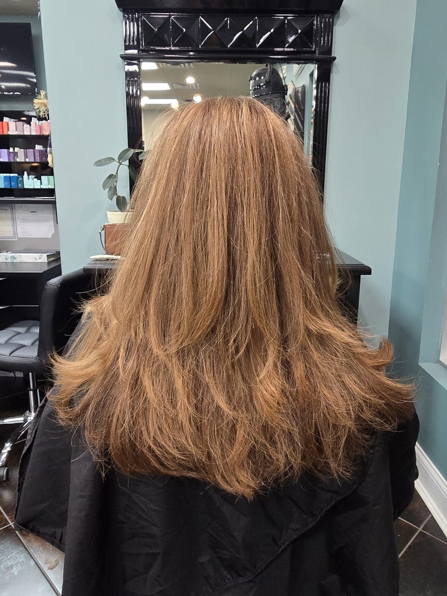 Back view of long strawberry blonde hair with round layers creating texture and movement, by Kristan Sayers at K Bella Hair Studio & Spa in Brighton, MI