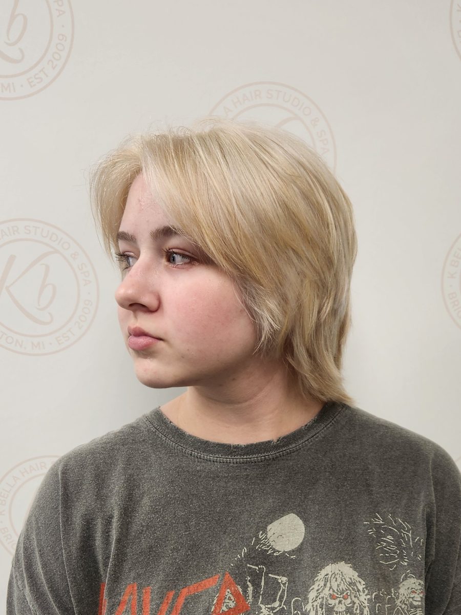 Close profile of finished shaggy crop with layered texture and blonde color by Siobhan Rozinski at K Bella Hair Studio & Spa in Brighton, MI