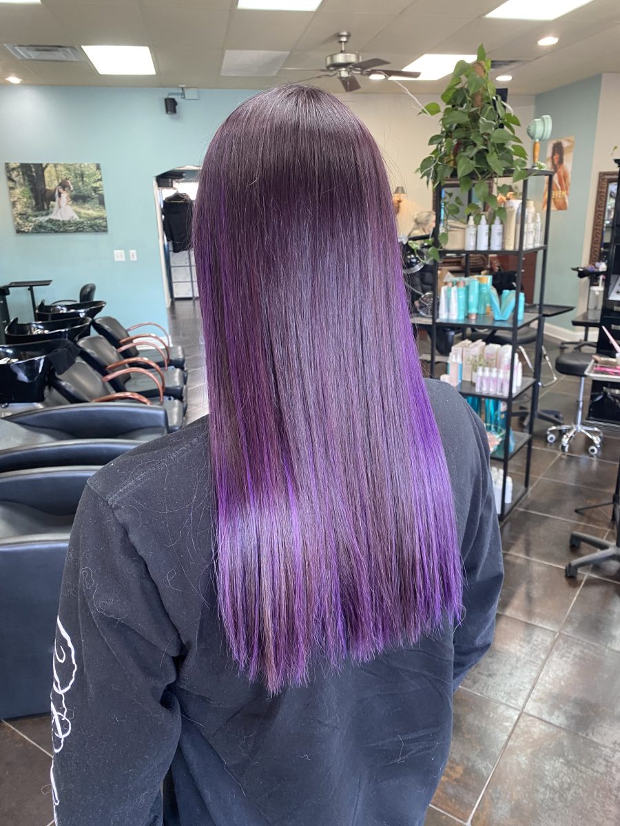 Sun-kissed balayage highlights accented with vivid color by Abbey French at K Bella Hair Studio in Brighton, MI
