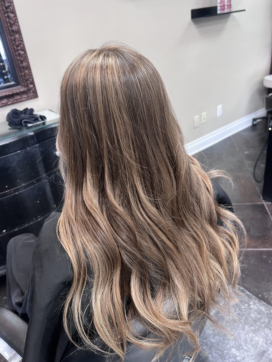 Sun-kissed balayage highlights by Kathryn McGinty at K Bella Hair Studio in Brighton, MI