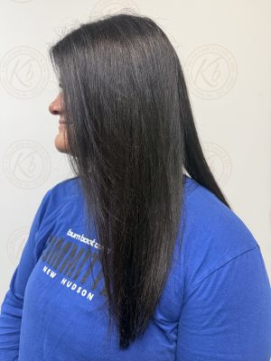Seamless hair extensions adding length and volume with polished styling by Raquel Vettese at K Bella Hair Studio & Spa in Brighton, MI - after transformation