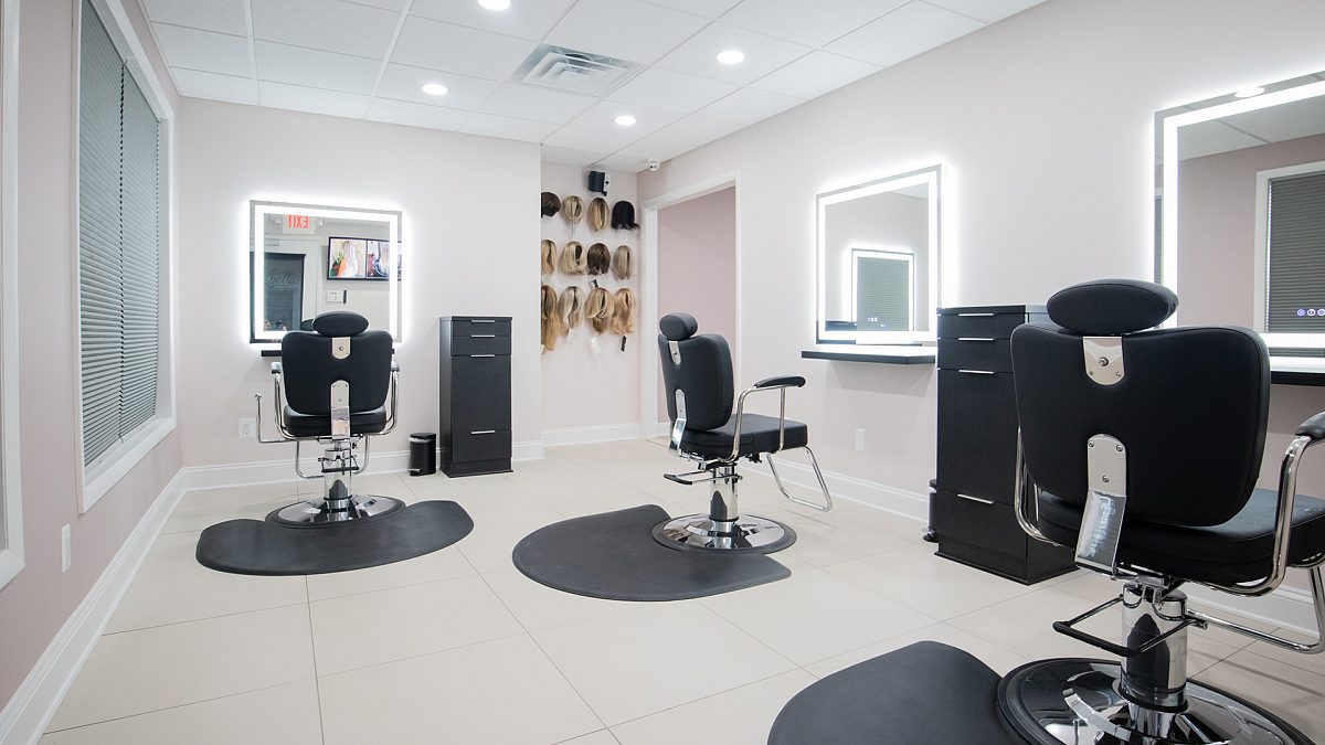 The private Wig Studio at K Bella with wig and topper displays for hair replacement